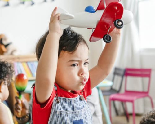 preschooler-enjoying-playing-with-his-airplane-toy-PRDTCJ4.jpg